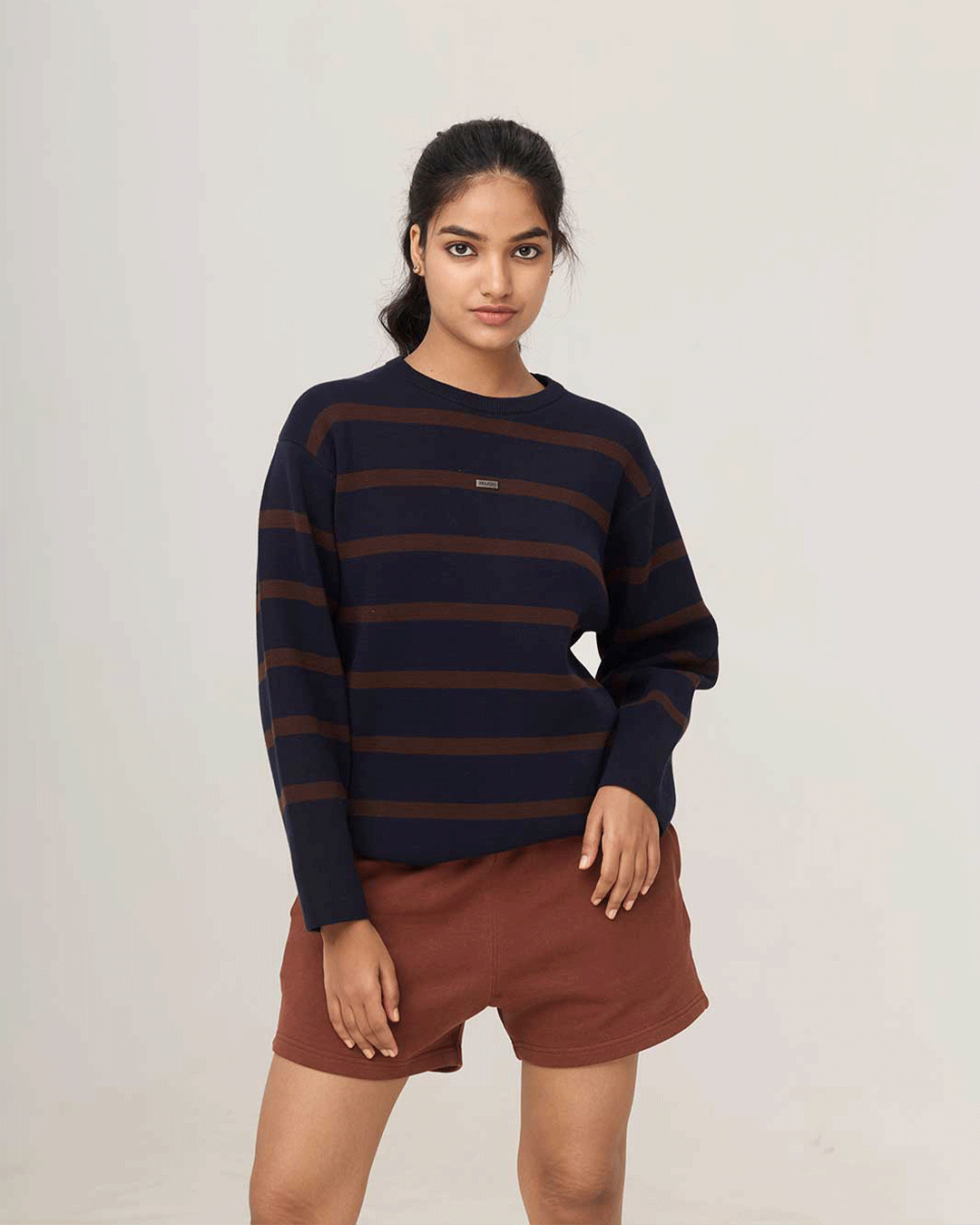 Woman wearing the RWDY Off Duty Shorts in Brown